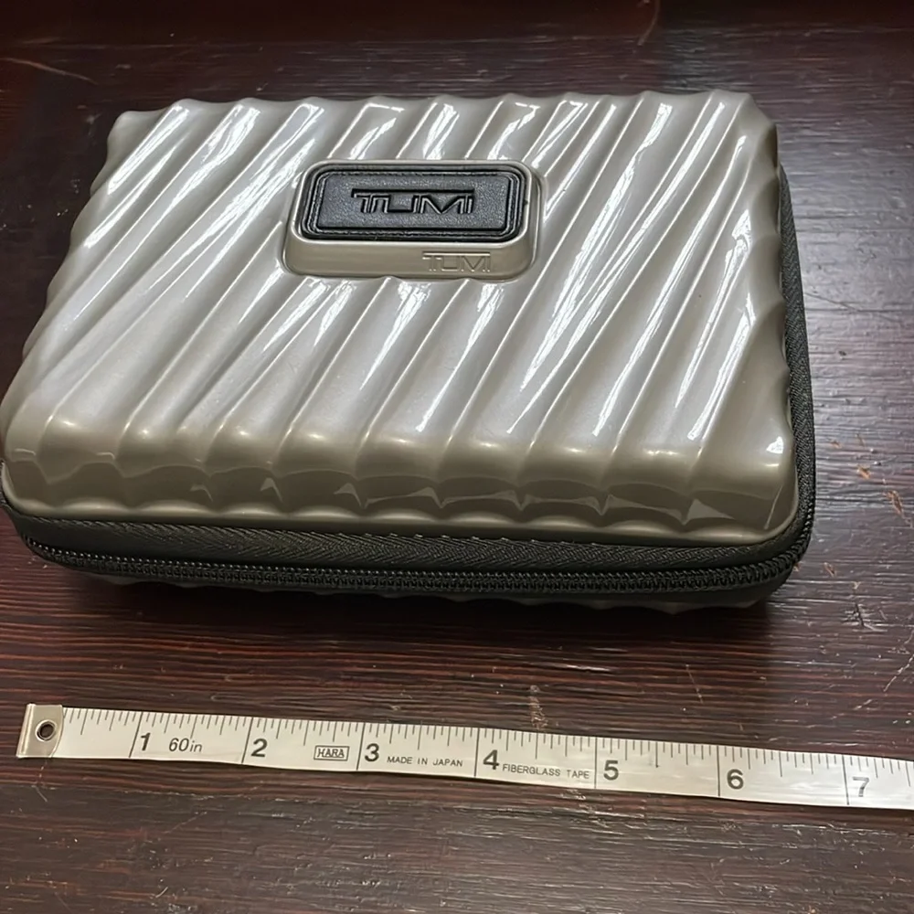 TUMI Silver Travel Size Hard Shell Case With Sturdy Black Zipper & Inner Elastic